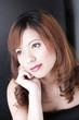 Studio shot of a lady with dyed hair daydreaming