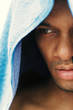 Close-up picture of an African American man with a blue towel covering his head