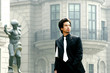 Man in business suit standing in front of a building 