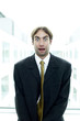 Man in business suit with his eyes opened up wide