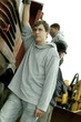A boy posing beside a truck 