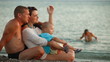 Family Relaxing on a Summer Beach at Sunset