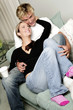 A couple cuddling on the couch