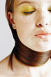 Woman tying her long hair around her neck