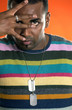 Man in colourful shirt showing four fingers 