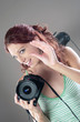 A woman photographer giving direction while holding a camera 