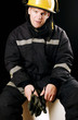 Fireman holding black gloves