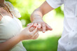 The bride wears the ring to the groom at a wedding
