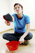 Photo: Woman holding a brush and dustpan Woman holding a brush and dustpan