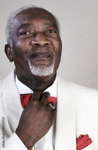 Photo: Old man adjusting his bow tie Old man adjusting his bow tie