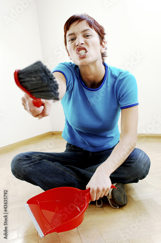 Photo: Woman holding a brush and dustpan Woman holding a brush and dustpan
