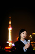 Businesswoman taking her own picture with a camera phone