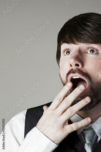 Photo: Businessman looking up in disbelief Businessman looking up in disbelief