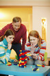 Family playing block game at home