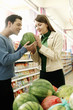 Couple choosing water-melon in the supermarket