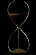 Sand trickling through hour glass