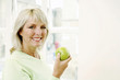 Woman holding a green apple