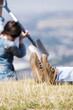Woman digging hole with a dead body beside her