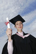 Woman in graduation robe showing off her scroll