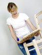 Woman fixing a broken chair