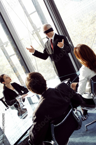 Photo: Blindfolded businessman talking in the conference room Blindfolded businessman talking in the conference room