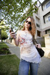 A teenage girl calling her friend on the mobile phone