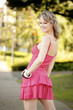 Photo: A teenage girl in pink dress posing for a photo shoot in the park A teenage girl in pink dress posing for a photo shoot in the park
