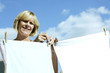 Senior woman hanging laundry on washing line