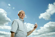 Senior man smiling while holding a mobile phone