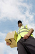 Low angle view of a delivery man carrying a box
