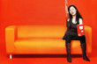 Woman gesturing while holding a packet of chips