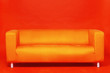 Bright orange couch on orange background