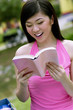 Woman smiling while reading book