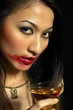 Woman with smudged lipstick holding a glass of champagne
