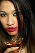 Woman with smudged lipstick holding a glass of champagne