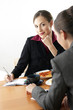 Businesswomen eating while having discussion