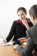 Businesswomen eating while having discussion