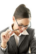 Businesswoman holding a pen while thinking
