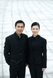 Businessman and businesswoman looking at the camera
