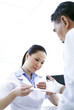 Nurse bandaging a patient's hand