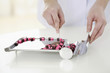 Doctor counting pills on pharmaceutical tray