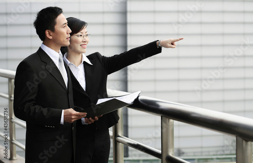 Photo: Businessman and businesswoman having discussion Businessman and businesswoman having discussion