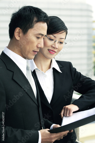 Photo: Businessman and businesswoman having discussion Businessman and businesswoman having discussion