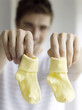 Father holding baby socks