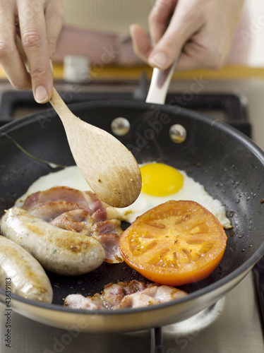 Photo: Frying bacon, eggs and sausages Frying bacon, eggs and sausages