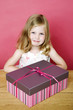Little girl taking photo with her present