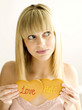 A young teen holding two cookies, love and hate