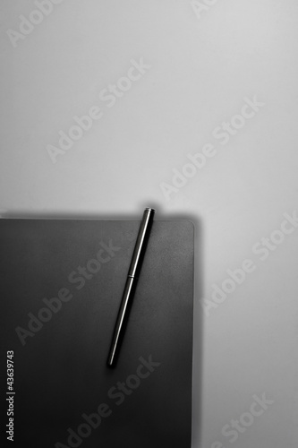 Photo: A pen attached to a book A pen attached to a book