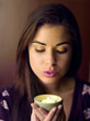 Woman holding a lighted aromatherapy candle