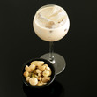 Cream liqueur with ice and bowl of mixed nuts